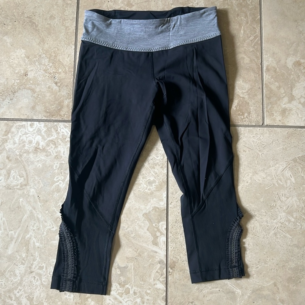 Lululemon black crop legging with ruffle detail.